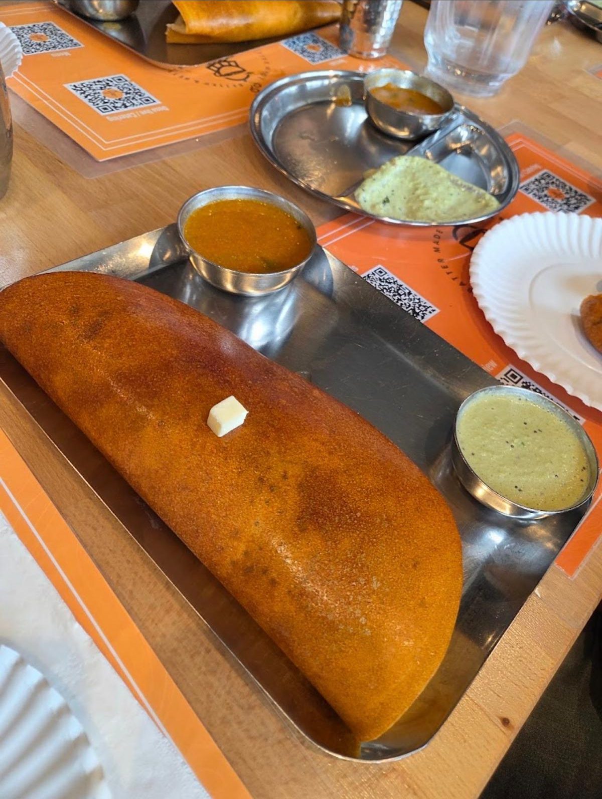 A dosa served with sambar and chutney at Malgudi