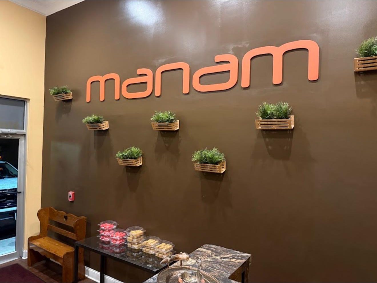 The Manam wordmark on the restaurant's entrance wall